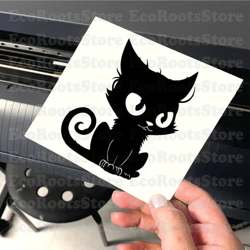 Cute black cat vinyl decal being held up, showcasing precision-cut design made with Roland cutting machine