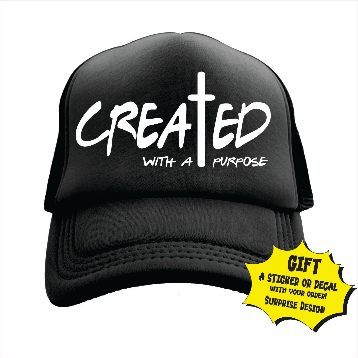 Black trucker hat cap with text 'CREATED WITH A PURPOSE' and a cross symbol on the front panel