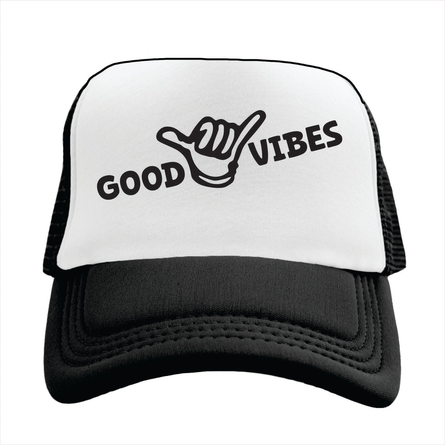 White and black cap with 'Good Vibes' text and hand sign on a white background