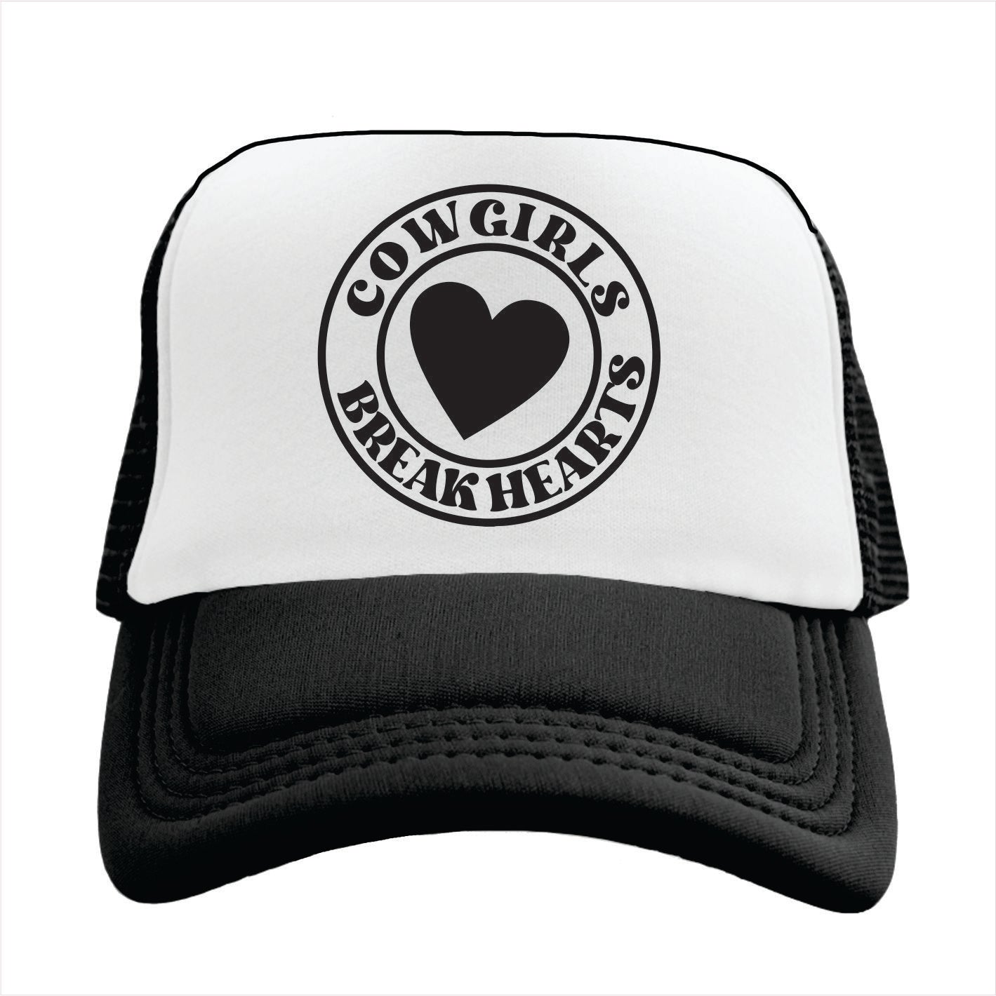 Black and white trucker hat cap with 'COWGIRLS BREAK HEARTS' text and a heart symbol printed on the front.