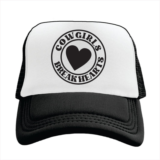 Black and white trucker hat cap with 'COWGIRLS BREAK HEARTS' text and a heart symbol printed on the front.