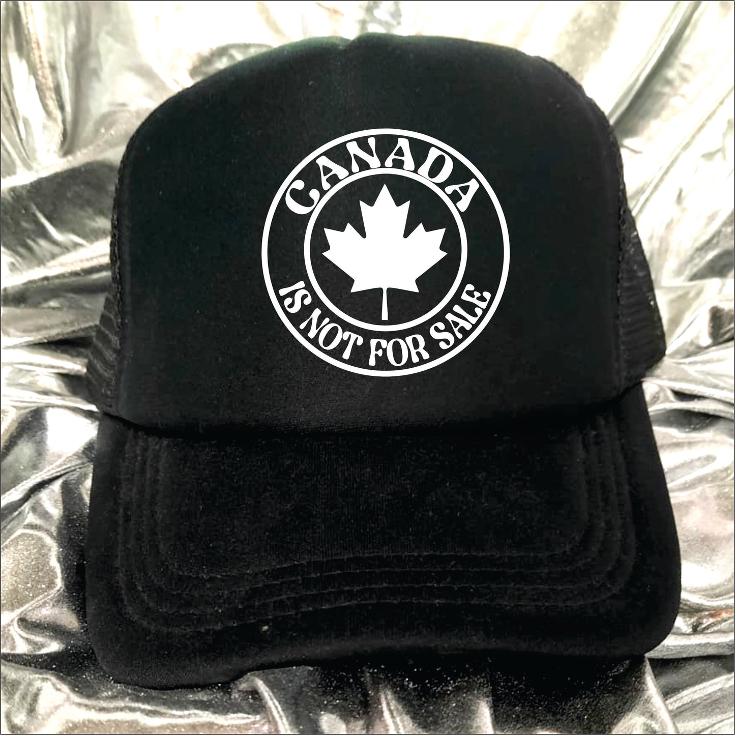 Black trucker hat cap with the text 'Canada is not for sale'.