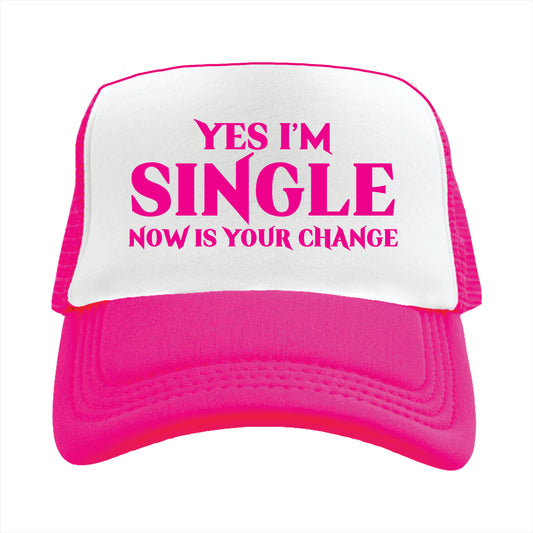 Pink and white trucker hat cap with the text 'YES I'M SINGLE NOW IS YOUR CHANGE' printed on the front.