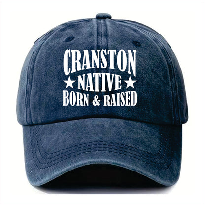 Blue cap with 'Cranston Native Born & Raised' text on a white background