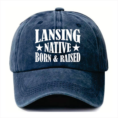 Blue cap with 'LANSING NATIVE BORN & RAISED' text on a white background
