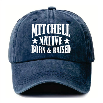 Blue cap with 'Mitchell Native Born & Raised' text on a white background