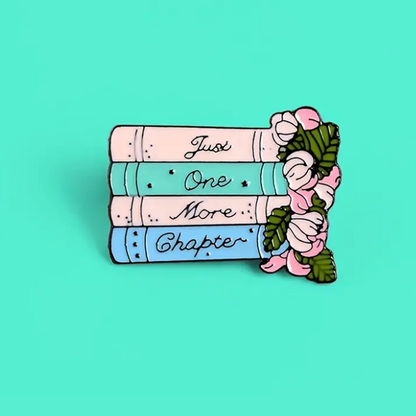 enamel pin showing 4 books, flowers and message just one more chapter ecorootstore