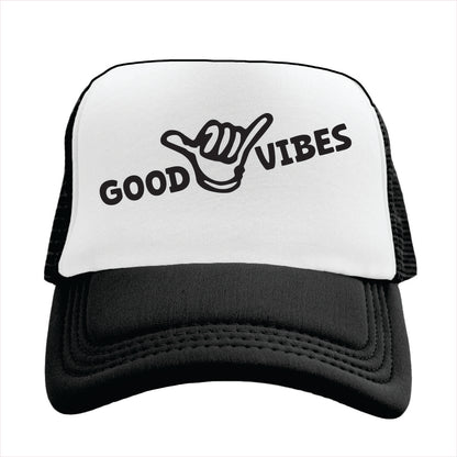 White and black cap with 'Good Vibes' text and hand sign on a white background