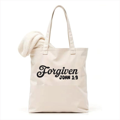 white  tote bag with 'Forgiven John 1:9' text on a white background