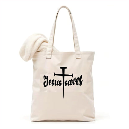 white tote bag with 'Jesus saves' text and cross design on a white background