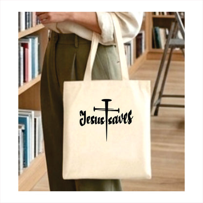 Person holding a tote bag with 'Jesus saves' text and cross design in a library setting.