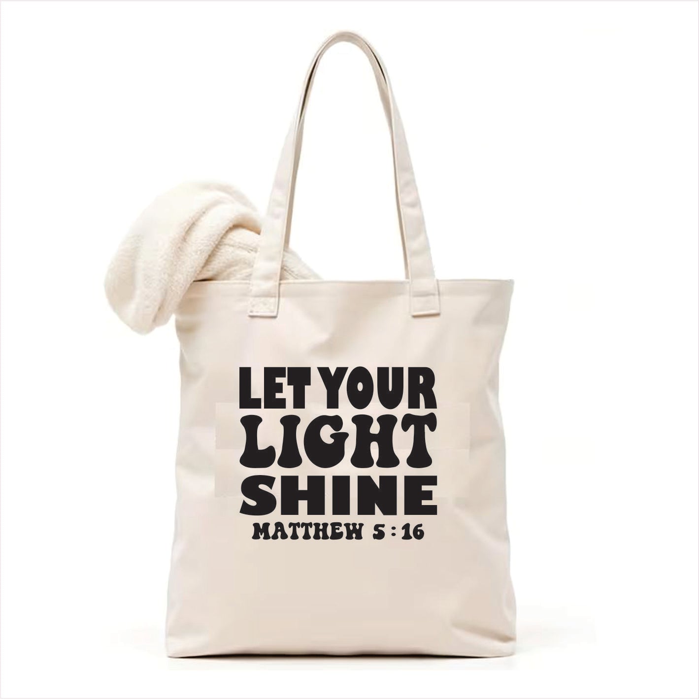 white tote bag with 'Let Your Light Shine' text on a white background