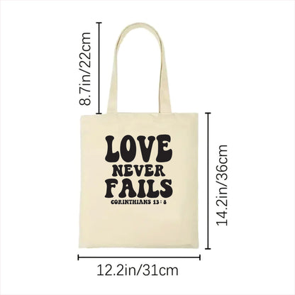 whit tote bag with 'Love Never Fails' text and measurements on a white background