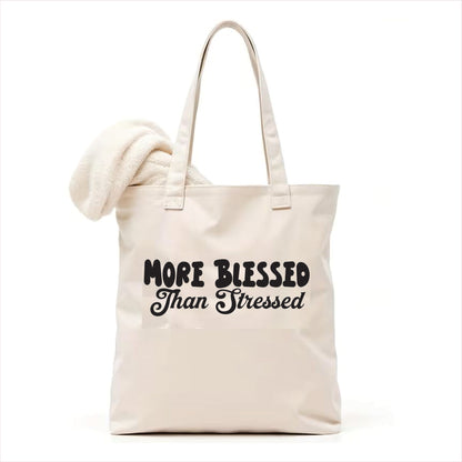 white tote bag with 'More Blessed Than Stressed' text on a white background