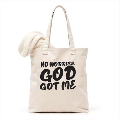 white tote bag with 'No worries, God got me' text on a white background