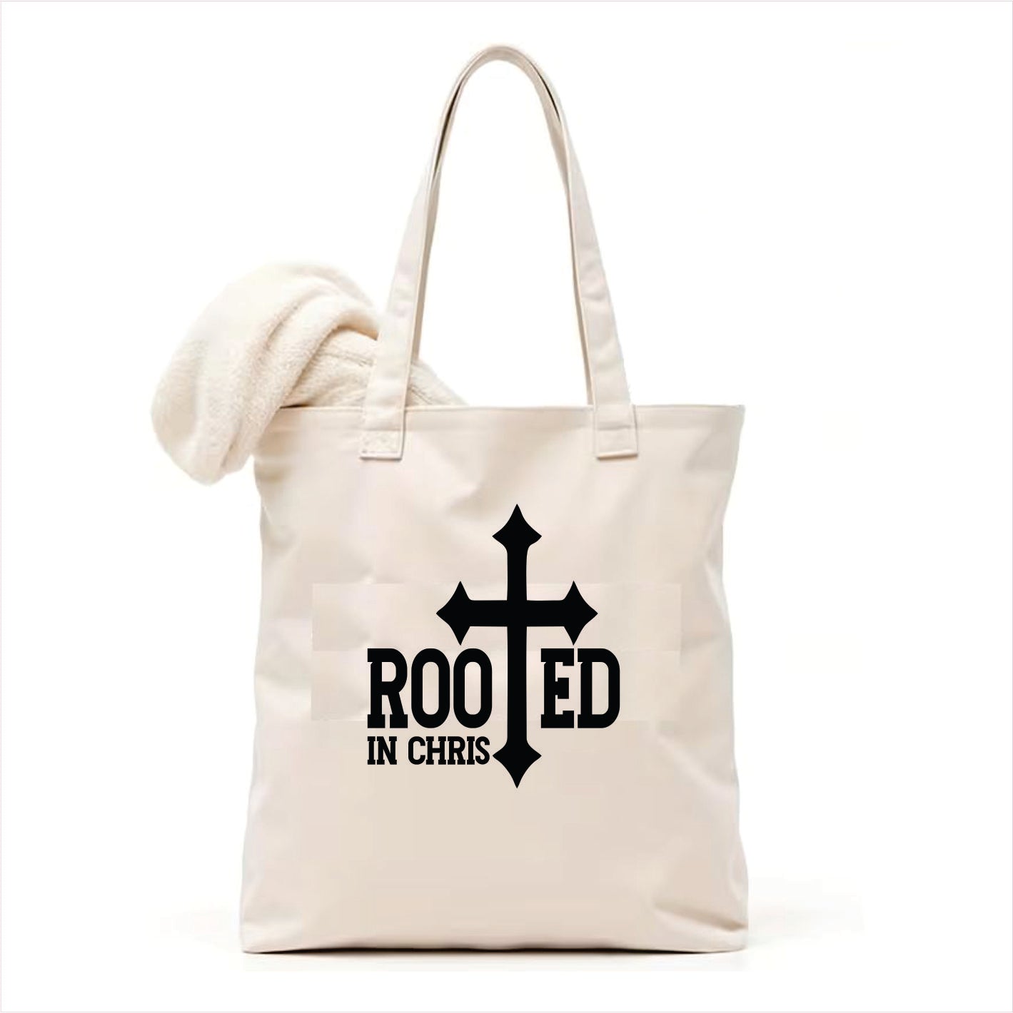 white tote bag with a black cross and 'Rooted in Chris' text on a white background