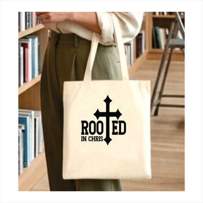 Tote bag with 'Rooted in Chris' design held by a person in a library setting