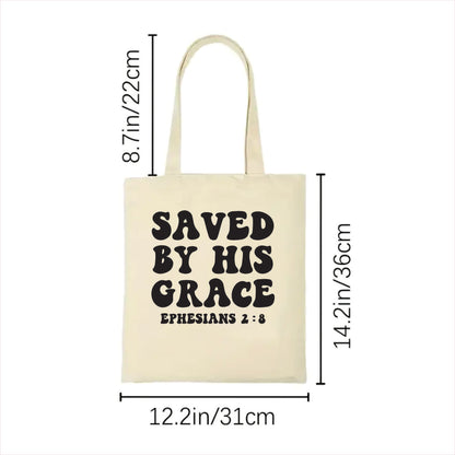 white tote bag with 'Saved by His Grace' text and measurements on a white background