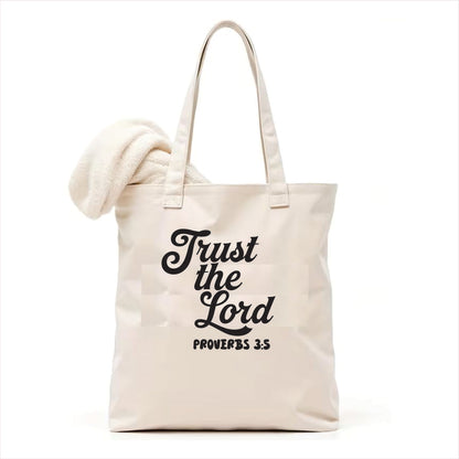 white tote bag with 'Trust the Lord Proverbs 3:5' text on a white background