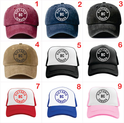 Nine Victoria BC Canada themed baseball caps in various colors on a white background.