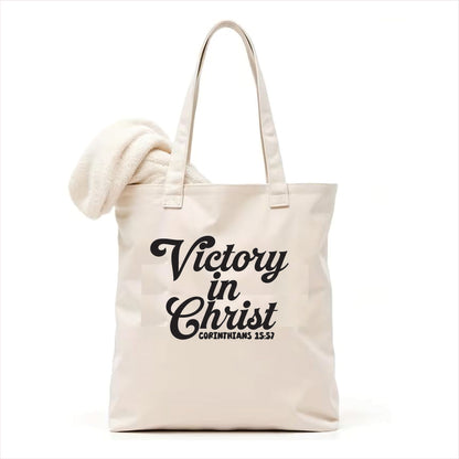 white tote bag with 'Victory in Christ' text on a white background