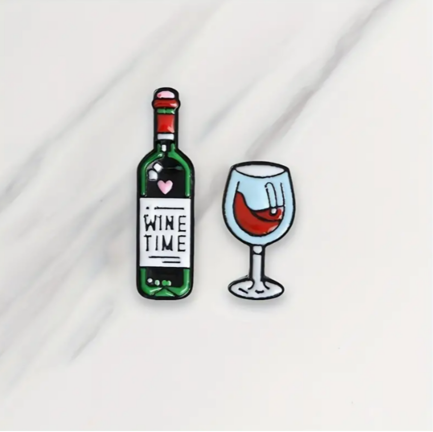 2 enamel pins with designs of a bottle of wine and a glass of wine